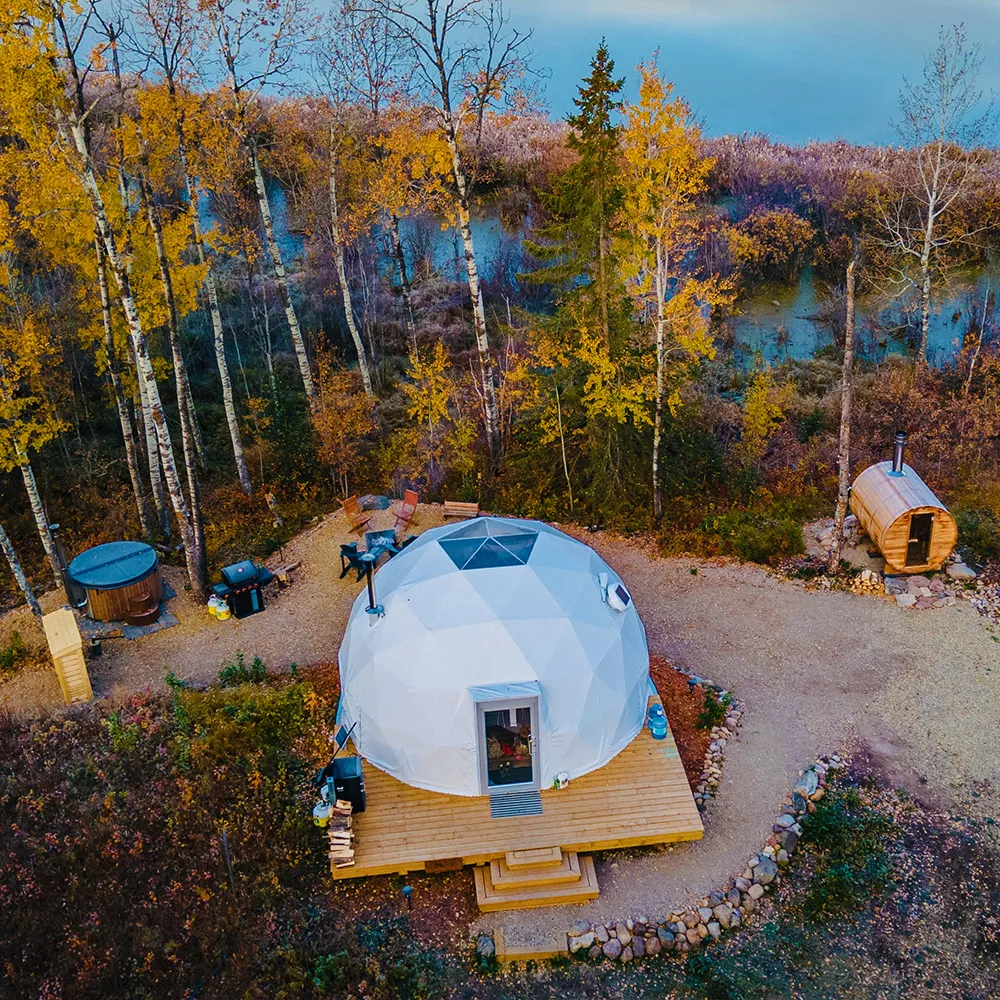 overhead shot of ignis dome with views of the campsite, outdoor hot tub, outdoor dry sauna and picnic table